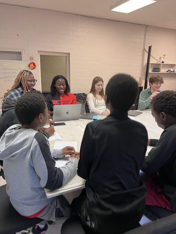 Step-Up fellows in a mentoring session with students at Box to Box